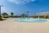 Clubhouse with resort style pool, seating, and water slides. With splash pad