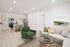 Modern open-concept living space featuring a sleek kitchen, comfortable seating area with stylish decor, and luminous natural light.