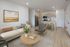 Inviting modern apartment living area with open kitchen, stylish decor, and elegant furnishings.