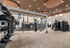 Modern fitness center with state-of-the-art equipment, including a punching bag, kettlebells, and versatile gym stations under stylish lighting.