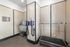 Modern pet spa room featuring a grooming station with industrial dryers and a wash area, perfect for luxury apartment living.