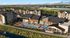 Luxurious apartment complex with stunning pool area, vibrant orange umbrellas, and scenic views, offering a perfect blend of relaxation and modern living.
