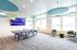 Modern recreational room featuring a ping pong table, vibrant lighting, and comfortable seating, perfect for social gatherings.
