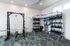 Modern fitness room featuring state-of-the-art equipment, including a weight rack, kettlebells, and resistance bands, perfect for a comprehensive workout.