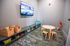 Inviting children's playroom with cozy seating, vibrant toys, and a mounted TV for entertainment.