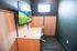 Sleek and modern study nook with wall-mounted TV, wooden desk, and ergonomic chair, ideal for focused work or relaxation.