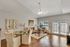 Inviting living and dining area with chic decor, featuring elegant seating, soft lighting, and ample natural light from large windows.