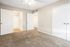 Bright and spacious carpeted bedroom with neutral walls, ceiling fan, and ample closet space, perfect for a cozy retreat.