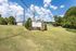 Welcome to Bessemer Place Apartments, nestled in lush greenery with a picturesque sky backdrop, offering a serene and inviting atmosphere.