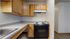 Charming kitchen with modern electric stove, ample wooden cabinetry, and sleek countertops, perfect for culinary creativity.