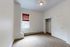 Bright, inviting room featuring modern carpet flooring, a built-in closet, and a large window with elegant blinds.