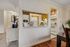 Charming apartment showcasing a cozy, stylish kitchen with wood accents, a peek into a warm living area, and elegant decor.