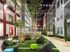 Courtyard at AMLI at Mueller with seating area on a grassy square in the center of surrounding pavement and shrubbery