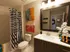 Bathroom with a tub, shower, and white tile. AMLI Dadeland