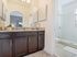 AMLI Toscana Place, interior, bathroom, large glass shower, dark cabinets, tile floor