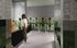 Rendering pet wash room with tile floors, a bathtub, green tile walls, and two pet treat vending machines at AMLI Old 4th apartments.