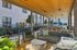 Covered lounge seating and dining area by the pool at AMLI Old 4th Ward