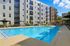 Corner view of pool deck at AMLI Old 4th Ward with lounge chairs and umbrellas