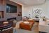 AMLI West Loop Media Room featuring a white couch and leather ottomans with a poker table and a modern fireplace