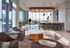 AMLI West Loop Resident Lounge featuring seating area, bar seating, large windows, and a man walking through the space.