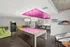 Resident clubroom at AMLI Dadeland apartments showcasing a pool table and an arcade machine and board games and couches