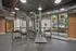 Interior view of a fitness center studio at AMLI Dadeland apartments with medicine balls and dumbbell weights and ropes