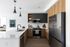 Modern kitchen with warm finish package and quartz countertops