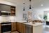Apartment kitchen and living area with cool finish package