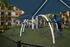Modern Children&rsquo;s covered playground at AMLI Dadeland with blue and white recreational equipment on faux grass foundation