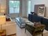 Elegant living room with cozy sofa, stylish armchair, and modern decor in a bright, inviting space.