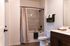 Modern bathroom with elegant tile design, soft lighting, and plush towels exuding a spa-like atmosphere.