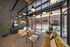 Chic modern lounge area with stylish seating, large windows, and pendant lighting, perfect for relaxation and entertainment.