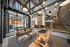 Modern lobby with high ceilings, stylish lighting, and chic seating area in a stunning apartment building.