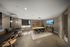 Modern, spacious meeting room with sleek furnishings, ambient lighting, and a wall-mounted screen, perfect for collaborative sessions.