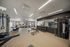 Modern fitness center equipped with treadmills, stationary bikes, and free weights, offering a bright and spacious workout environment.