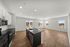 Bright, open-concept apartment with a modern kitchen, sleek countertops, and expansive windows offering city views.