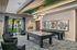 Stylish entertainment lounge with modern decor, featuring a pool table and elegant seating.