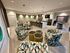 Stylish communal lounge featuring modern geometric chairs, cozy lighting, and a sleek kitchen area.