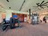 Modern fitness center with high-end exercise equipment, spacious interior, and stylish lighting design.