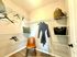 Spacious walk-in closet with sleek wire shelving, a cozy chair, and ample storage for a luxurious living experience.