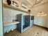 Chic pet grooming station with modern tile design, delightful dog-themed wallpaper, and playful 'You're Paw-some!' neon sign.