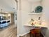 Inviting apartment with a chic nook area, modern kitchen island with seating, and elegant decor.