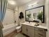 Modern bathroom with elegant fixtures, sleek vanity, and bright lighting, ideal for luxury living.