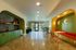 Modern communal area with vibrant green cabinetry, cozy built-in seating, and stylish lighting, offering a welcoming atmosphere.