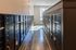 Bright and modern mailbox area with sleek metal lockers, natural lighting, and polished floors in a contemporary apartment complex.