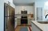 Modern kitchen featuring sleek stainless steel appliances, elegant white cabinetry, and a stylish countertop.