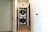 Modern apartment featuring a convenient in-unit stacked washer and dryer in a sleek hallway.