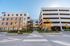 Modern apartment complex with vibrant mural art and convenient parking facilities, offering urban living with a touch of creativity.