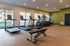 Modern fitness center featuring state-of-the-art treadmills and exercise equipment in a bright, spacious setting.