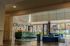 Vibrant apartment lobby featuring modern furniture, expansive windows with natural light, and stylish decor.